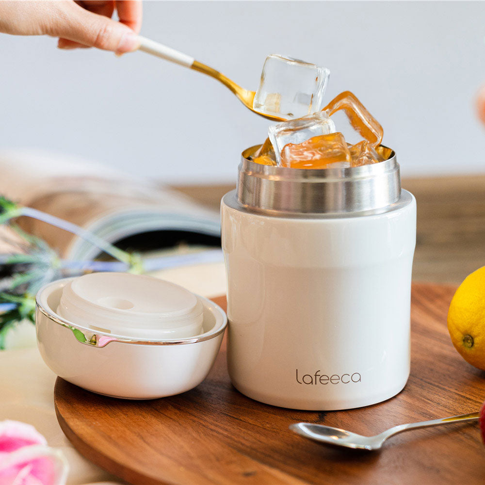 White Lafeeca coffee canister filled with ice cubes, lid beside it